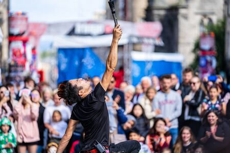 Edinburgh, Scotland, August 8th 2019. Fire performance includes skills based on juggling, baton twirling, poi spinning, and other forms of object manipulationのeditorial素材