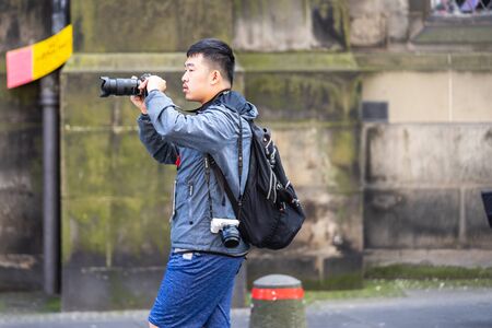 Edinburgh, Scotland, August 8th 2019. Photographer or Blogger shooting photos or video, using modern simple set of equipmentのeditorial素材