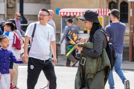 Cambridge, UK, August 1, 2019. Happy chinese tourists in cambridgeのeditorial素材