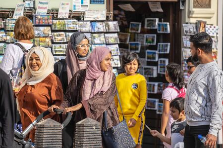 Cambridge, UK, August 1, 2019. Happy muslim family at front of the card shopのeditorial素材