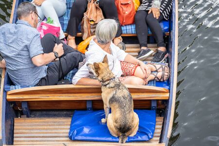 Cambridge, UK, August 1, 2019. A punt is a flat-bottomed boat with a square-cut bow, designed for use in small rivers or other shallow water. Cambridge, England.の写真素材