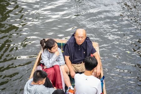 Cambridge, UK, August 1, 2019. A punt is a flat-bottomed boat with a square-cut bow, designed for use in small rivers or other shallow water. Cambridge, Englandのeditorial素材