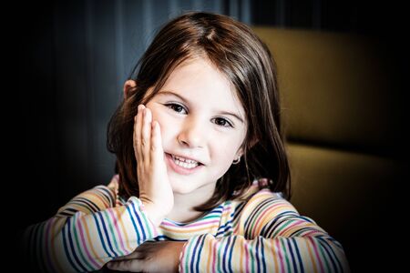 Happy smiling little girl lying on the table.Soft focus