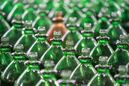 Glass bottles texture. A lot of green glass empty bottles, selective focus close up view.の写真素材