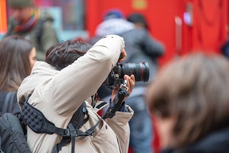 London, January 26, 2020. Photographer taking photos in London Chinatown. Chinese New Year Celebrations. Selective focusのeditorial素材