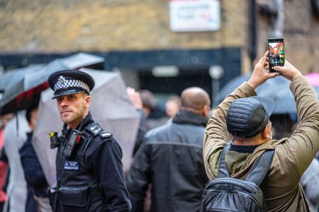 London, January 26, 2020. British Police officers patrolling the streets of England wearing stab vestsのeditorial素材