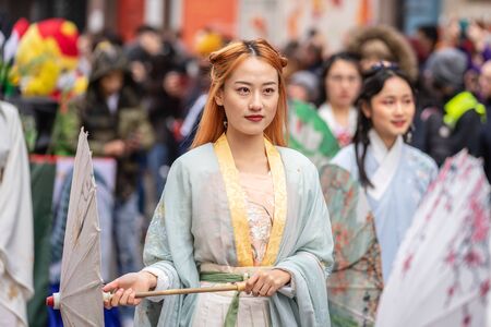London, January 26, 2020. Portrait of beautiful young Chinese women wear in Traditional Chinese National Costume with umbrellaのeditorial素材