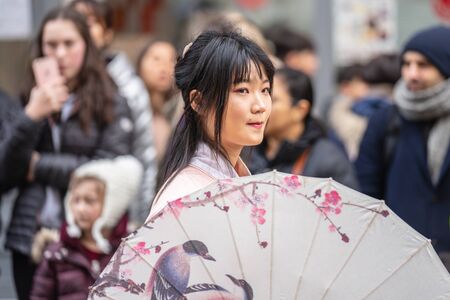 London, January 26, 2020. Portrait of beautiful young Chinese women wear in Traditional Chinese National Costume with umbrellaのeditorial素材