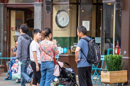 Cambridge, UK, August 1, 2019. Tourists walking down at the street of Cambridge on a busy sunny day...
