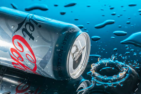 Bedford,UK,May 16,2020. Diet Coke, Coca-Cola light or Light Taste Coca-Cola can with splashes of water on a black background and water dropsのeditorial素材