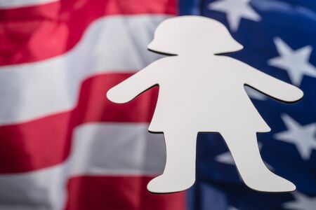 Large paper person shape on mirror background with American flag reflected in it. 4th of july background photos conceptの写真素材