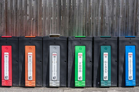 Recycling bins. Common colour coding is blue for paper, grey or black for tins and cans, red for plastics, yellow for textiles, green for glass and lime green for food waste.Cornwall,UK, July 5, 2020の写真素材