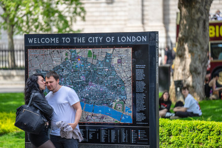 A couple in love kisses against the background of a map of London. UK, London, May 29, 2021のeditorial素材