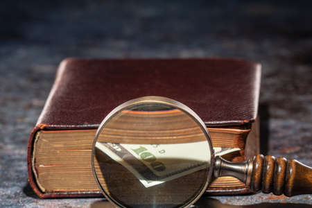 One hundred dollar bookmark note in an old bookの写真素材