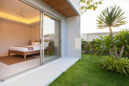 Luxury Interior design in bedroom of pool villa with cozy king bed. Bedroom with high raised ceilingの写真素材