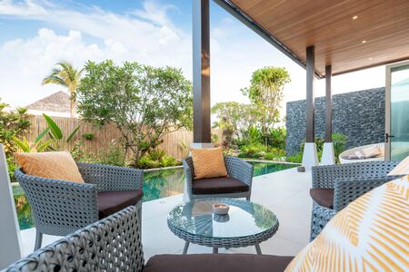 chair and table at the pool villas with green gardenの写真素材