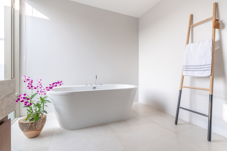 Luxury bathroom features bathtub with flowerの写真素材