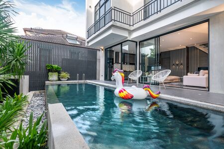 exterior home with swimming pool and floating unicorn in the houseの写真素材