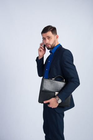 Young businessman talking on the phoneの写真素材