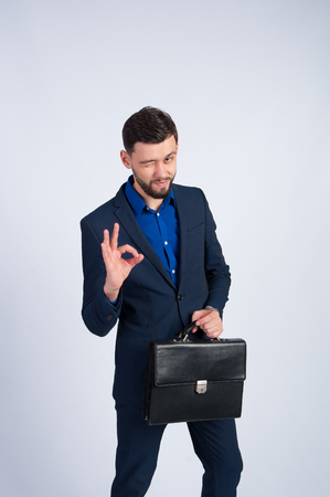 Young businessman shows OKの写真素材