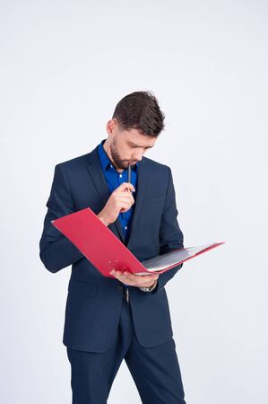 A young businessman looking through a folderの写真素材