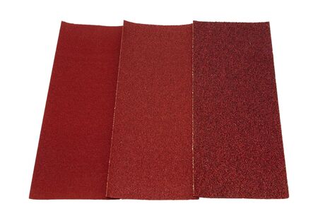 three different grit sandpaper on a white backgroundの写真素材