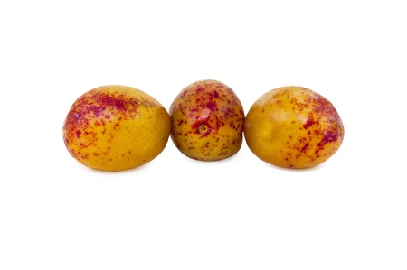 three yellow plums, isolated on white backgroundの写真素材