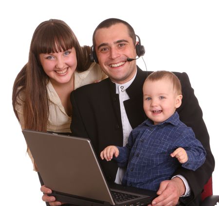 Happy family with laptop and headset. Isolated.の写真素材