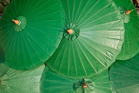 Background of green chinese umbrella. Design. の写真素材