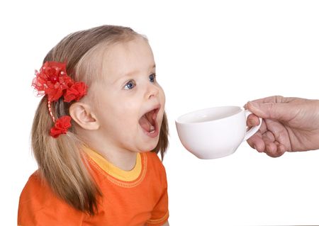 Child drink  water from  white cup. Isolated.の写真素材