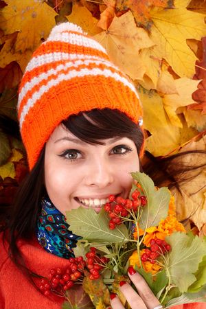 Girl in autumn orange hat on leaf group. Outdoor.の写真素材