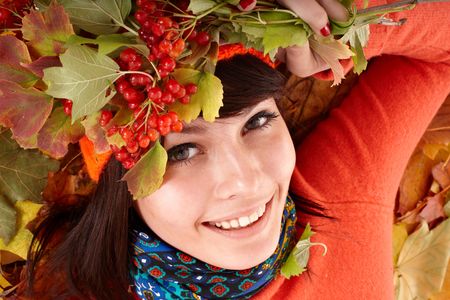  Girl in autumn orange hat on leaf group and berry. Outdoor.の写真素材
