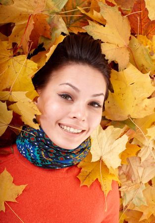 Girl in autumn orange hat on leaf group. Outdoor.の写真素材