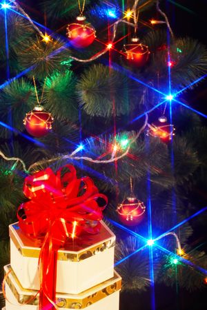 Christmas tree with flash and  gift box. Black background.の写真素材