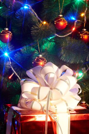 Christmas tree with flash and  gift box. Black background.の写真素材