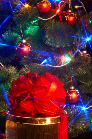 Christmas tree with flash and  gift box. Black background.の写真素材