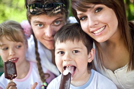 Happy family and group children eat ice cream. Outdoor.の写真素材