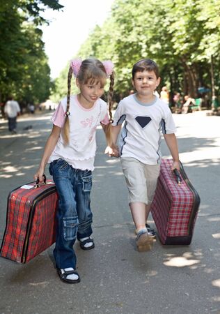 Children with suitcase run. Children tourism.の写真素材
