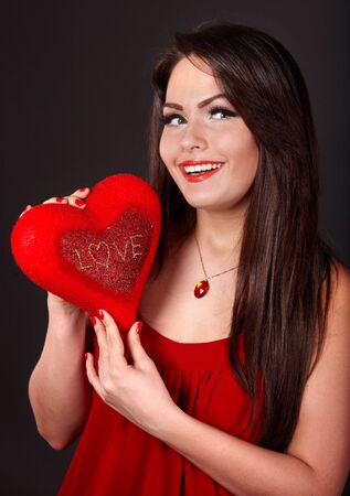 Girl with heart  in red on grey background. Valentines day.の写真素材