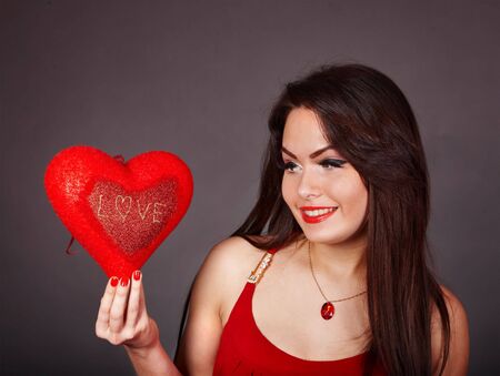 Girl with heart  in red on grey background. Valentines day.の写真素材