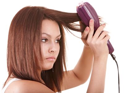 Beautiful girl with hair straightener. Isolated.の写真素材