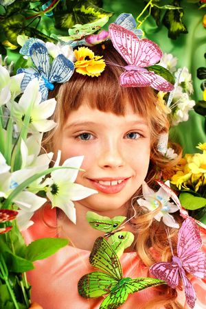  Beautiful girl with butterfly and flower on green grass.の写真素材