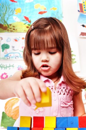  Child with wood block and construction set in play room. Preschool.の写真素材