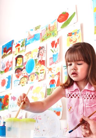 Child with picture and brush in play room. Preschool.の写真素材