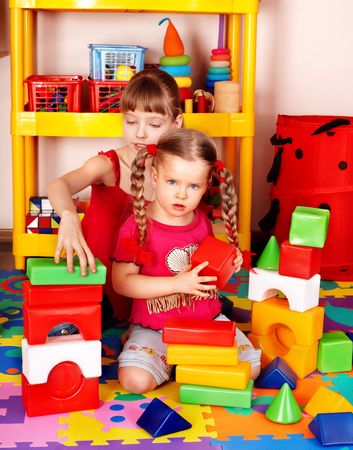   Children  with  block  in play room.  Preschool.の写真素材
