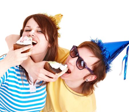 Man in party hat and girl eating cake. Isolated.の写真素材