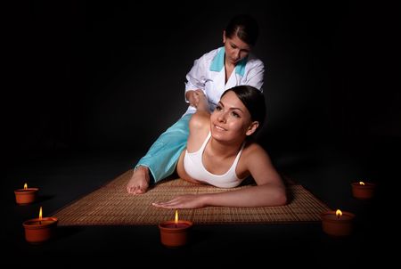 Beautiful white girl having thai massage.の写真素材