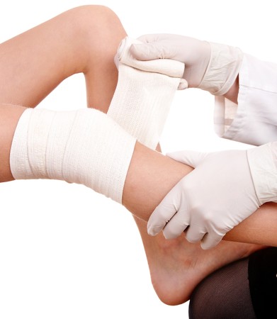 First aid at knee trauma. Isolated.の写真素材