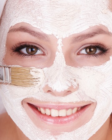 Young womanl with clay facial mask.の写真素材