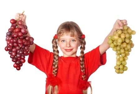 Little girl takes bunch of grape. Isolated.の写真素材